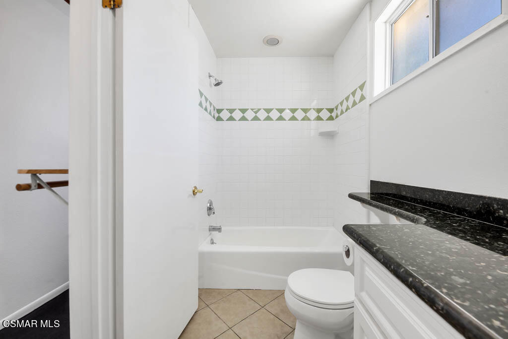 2039 Madrone Street Simi Valley, CA 93065 - Photo 15 of 35 a bathroom with a granite countertop bathtub shower sink vanity and toilet