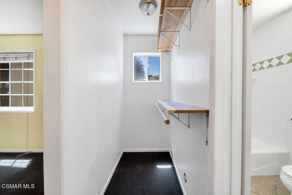 2039 Madrone Street Simi Valley, CA 93065 - Photo 16 of 35 a view of a hallway with wooden floor and a bathroom
