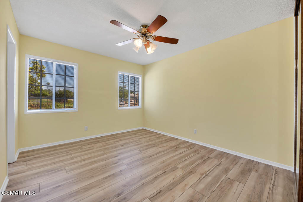 2039 Madrone Street Simi Valley, CA 93065 - Photo 18 of 35 a view of an empty room with wooden floor and a window