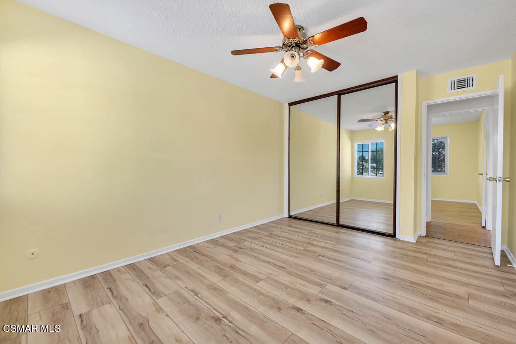 2039 Madrone Street Simi Valley, CA 93065 - Photo 19 of 35 an empty room with wooden floor and a ceiling fan