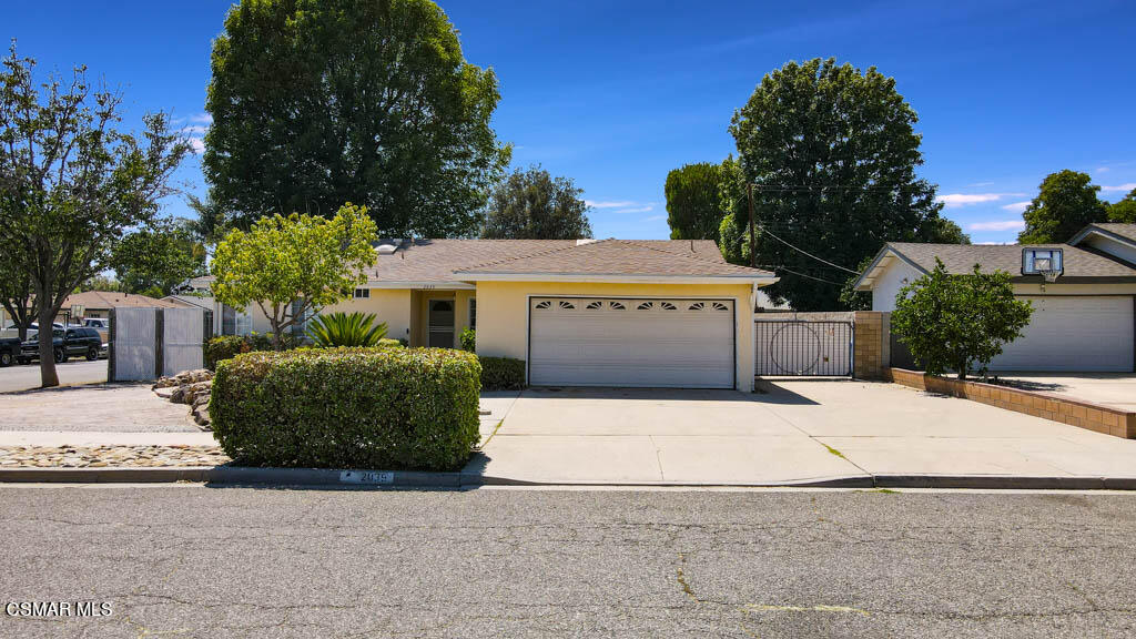 2039 Madrone Street Simi Valley, CA 93065 - Photo 22 of 35 a view of a white house with a yard and a large window