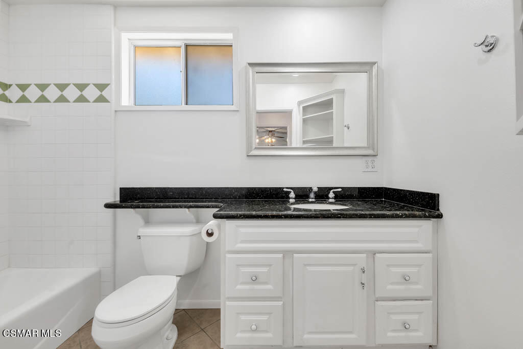 2039 Madrone Street Simi Valley, CA 93065 - Photo 31 of 35 a bathroom with a sink a toilet a vanity and mirror