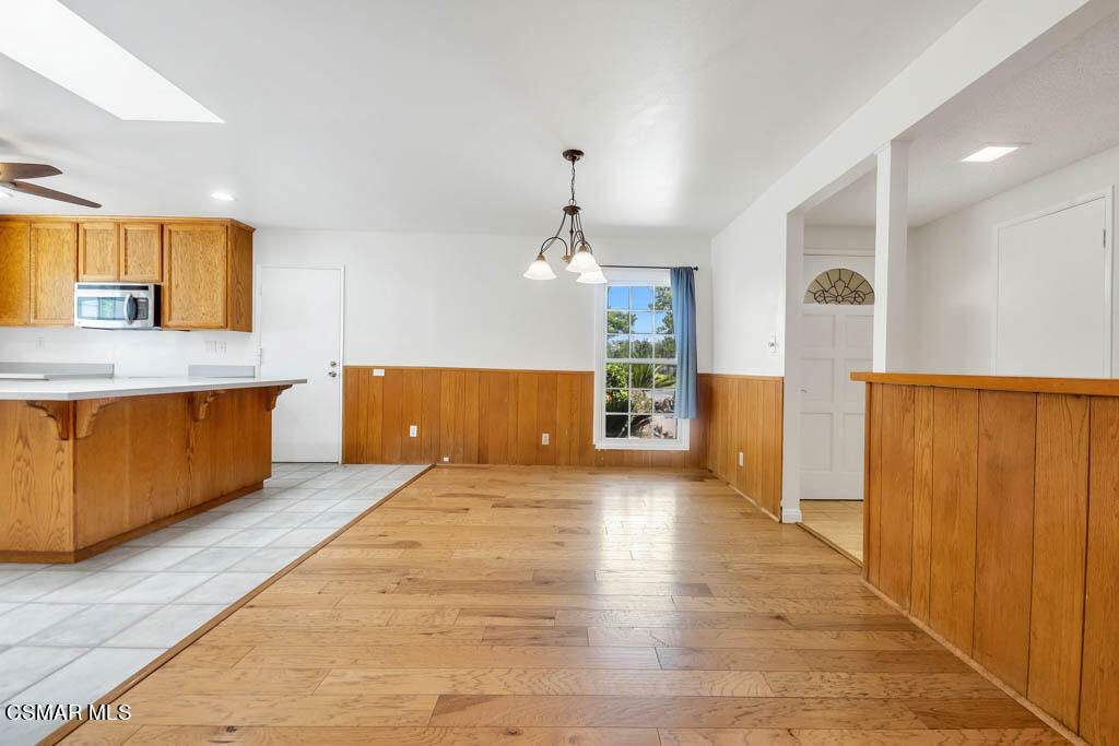 2039 Madrone Street Simi Valley, CA 93065 - Photo 4 of 35 a view of a kitchen with a sink cabinet and a living room