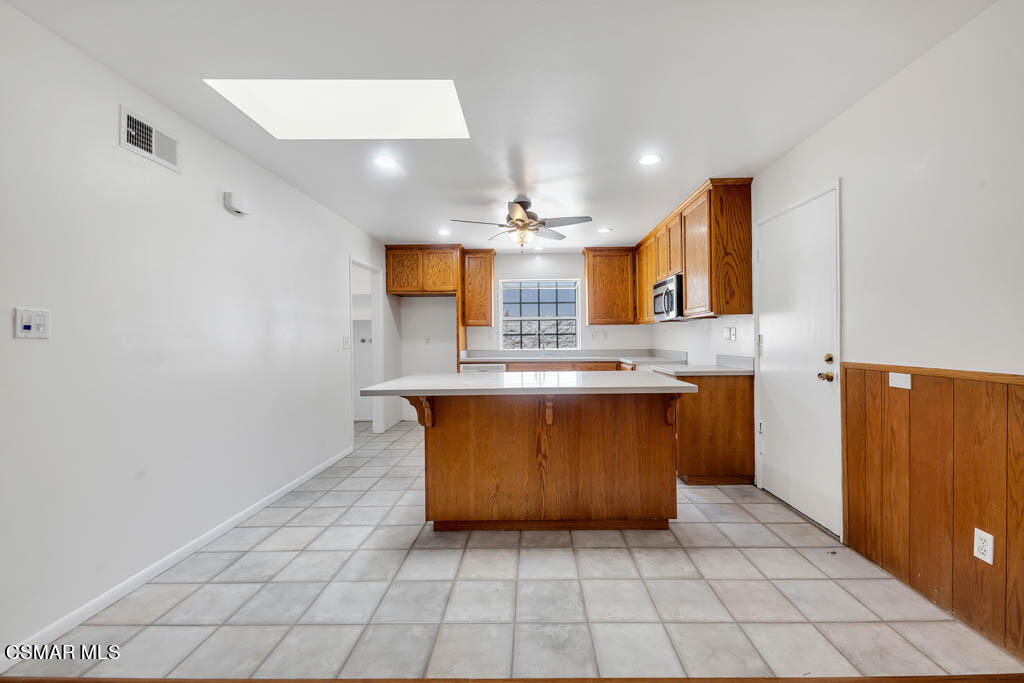 2039 Madrone Street Simi Valley, CA 93065 - Photo 6 of 35 a large kitchen with a sink a counter space cabinets and appliances