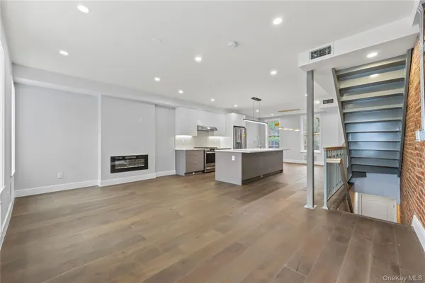 a view of a kitchen with chairs and cabinets
