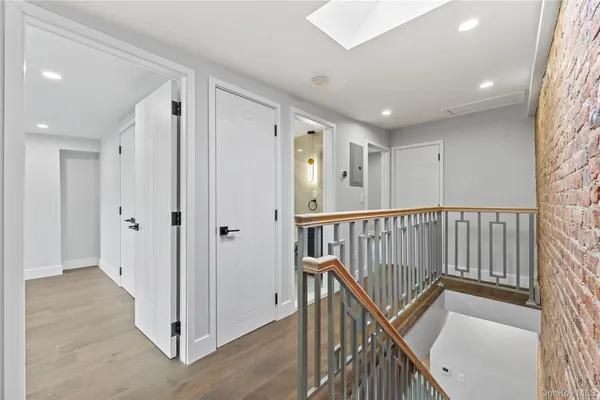 a view of a hallway with entryway and stairs