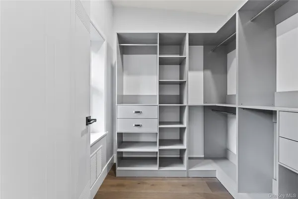 a view of walk in closet with empty racks