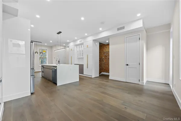 a view of a kitchen with a refrigerator and a sink