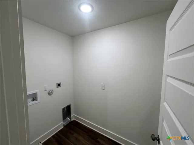 a room with linen closet and wooden floor