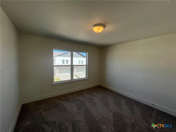 an empty room with a empty space and a window