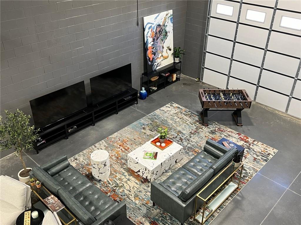 5725 Stables Way, Unit 308 Alpharetta, GA 30004 - Photo 3 of 7 a living room with furniture and a flat screen tv