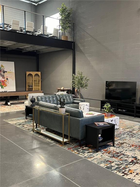 5725 Stables Way, Unit 308 Alpharetta, GA 30004 - Photo 4 of 7 a living room with furniture and a flat screen tv