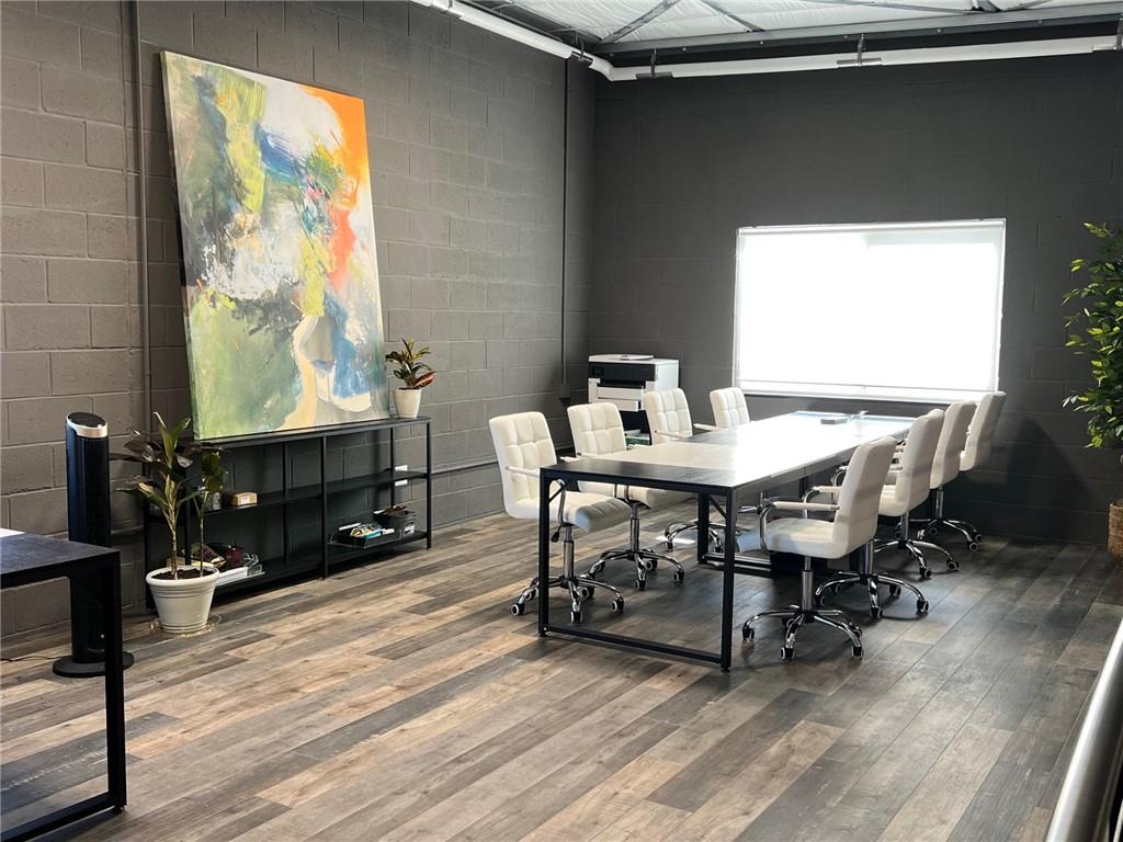 5725 Stables Way, Unit 308 Alpharetta, GA 30004 - Photo 5 of 7 a view of a dining room with furniture window and wooden floor