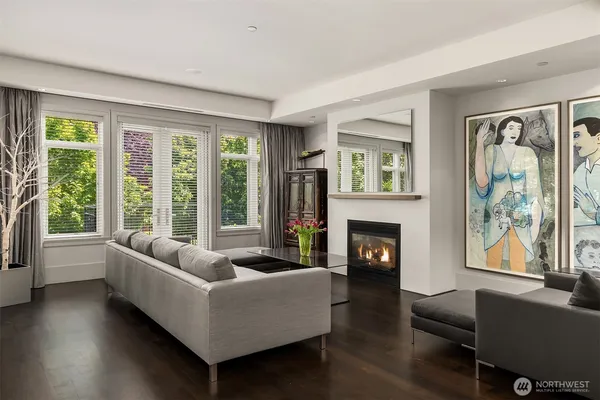 a kitchen with a stove a sink a refrigerator and chairs