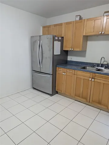 a kitchen with stainless steel appliances granite countertop a refrigerator sink and cabinets