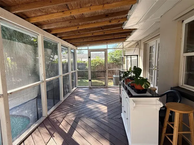 a view of a porch with furniture and front door