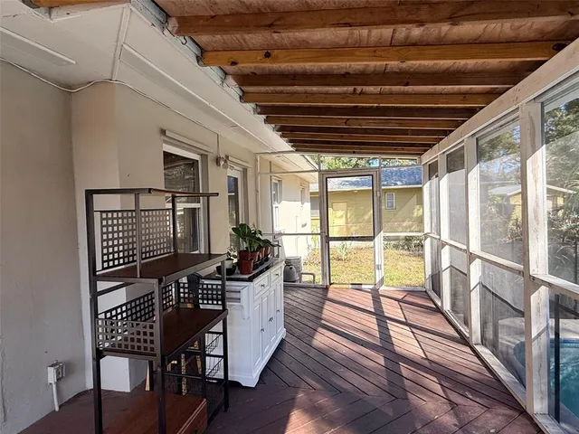 a view of a porch with furniture and a yard