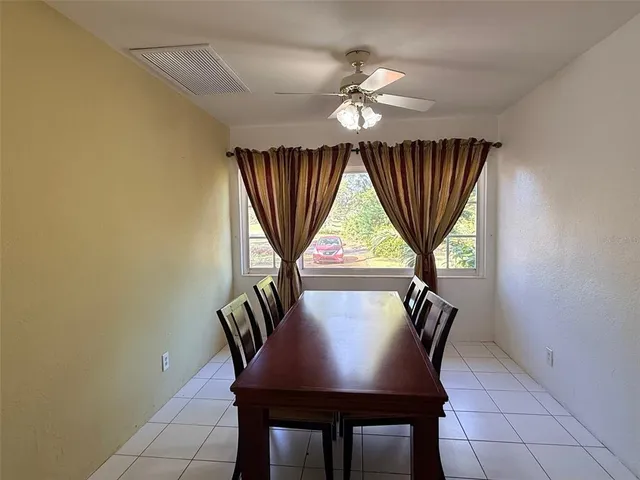 a view of a dining room with furniture and window