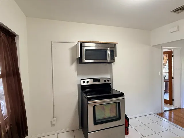 a kitchen with a stove and a microwave