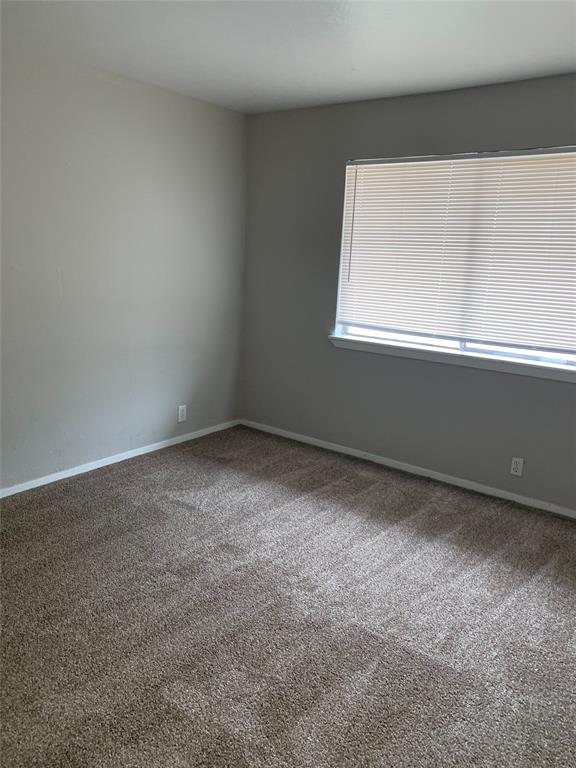 4606 Monarch Street, Unit 109 Dallas, TX 75204 - Photo 13 of 17 Carpeted empty room featuring baseboards