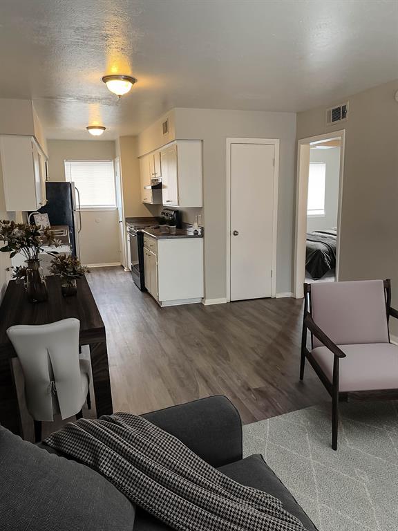 4606 Monarch Street, Unit 109 Dallas, TX 75204 - Photo 4 of 17 Living room featuring dark wood-style floors and baseboards