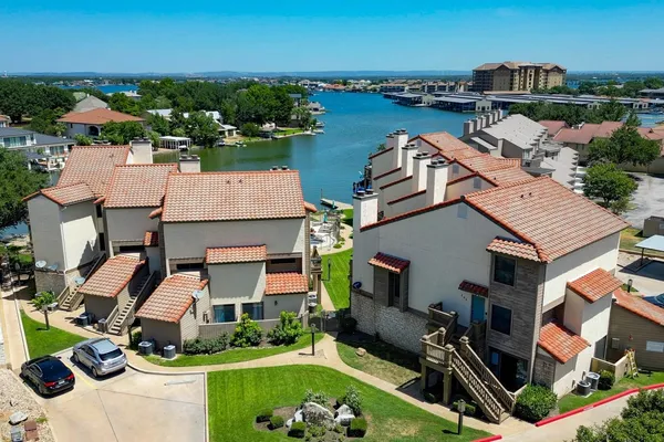 an aerial view of a house with outdoor space swimming pool and ocean view