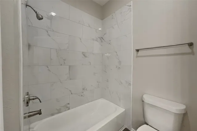 a bathroom with a bathtub and a toilet