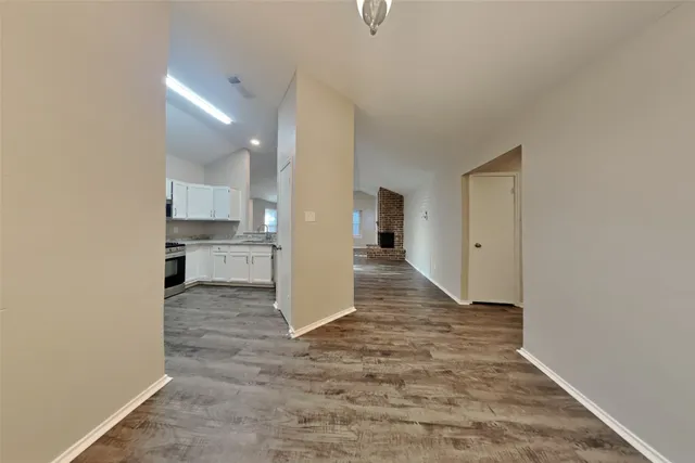 a view of a kitchen with a sink and cabinets