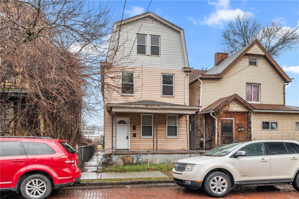 a front view of a house with parking space