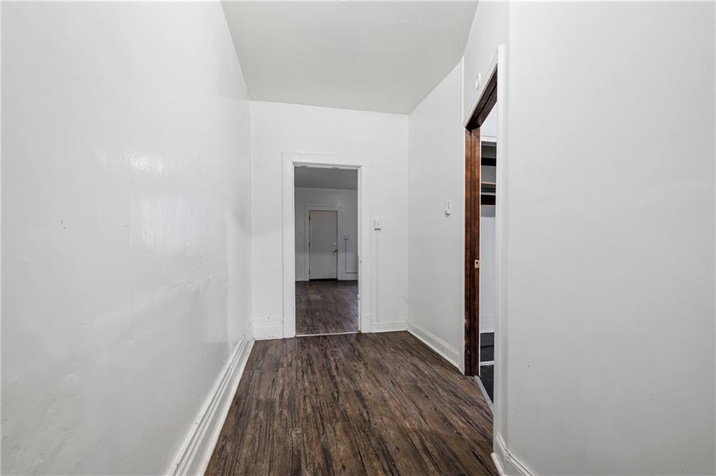 902 Robinson Street McKees Rocks, PA 15136 - Photo 11 of 31 a view of a room with wooden floor and a hallway