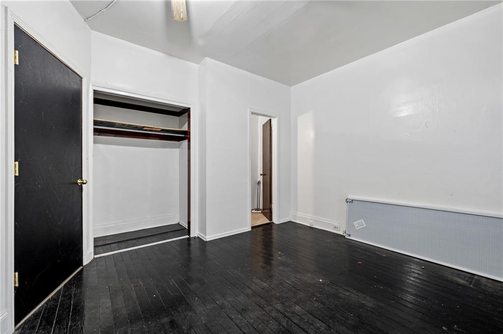 902 Robinson Street McKees Rocks, PA 15136 - Photo 16 of 31 an empty room with wooden floor and closet