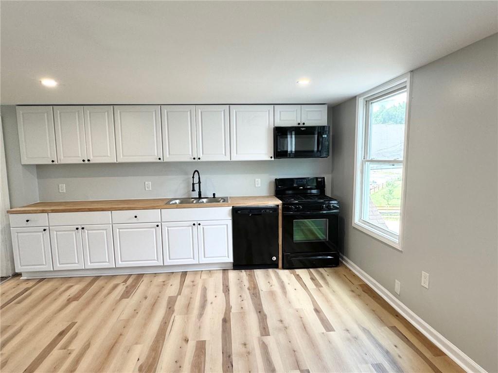 902 Robinson Street McKees Rocks, PA 15136 - Photo 20 of 31 a kitchen with granite countertop white cabinets and stainless steel appliances