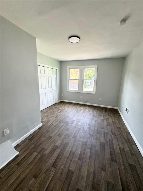 902 Robinson Street McKees Rocks, PA 15136 - Photo 23 of 31 an empty room with wooden floor and windows