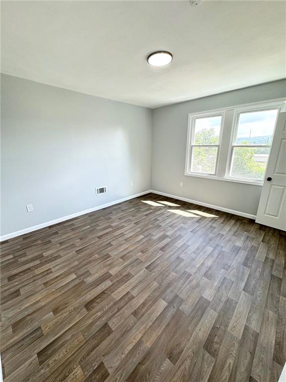 902 Robinson Street McKees Rocks, PA 15136 - Photo 24 of 31 an empty room with wooden floor and windows