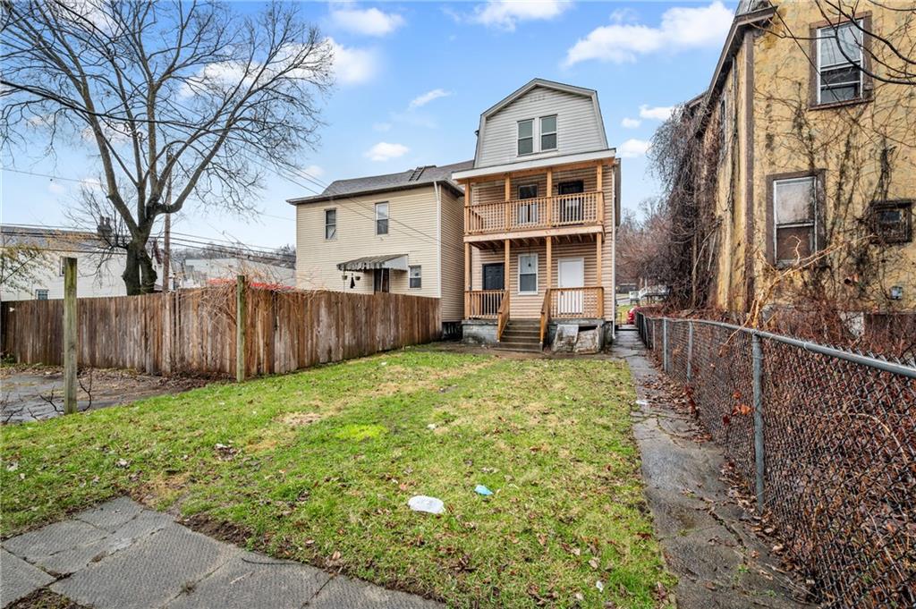 902 Robinson Street McKees Rocks, PA 15136 - Photo 28 of 31 a view of a house with backyard and wooden fence