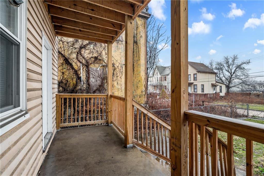 902 Robinson Street McKees Rocks, PA 15136 - Photo 5 of 31 a view of a porch with wooden floor and floor to ceiling window