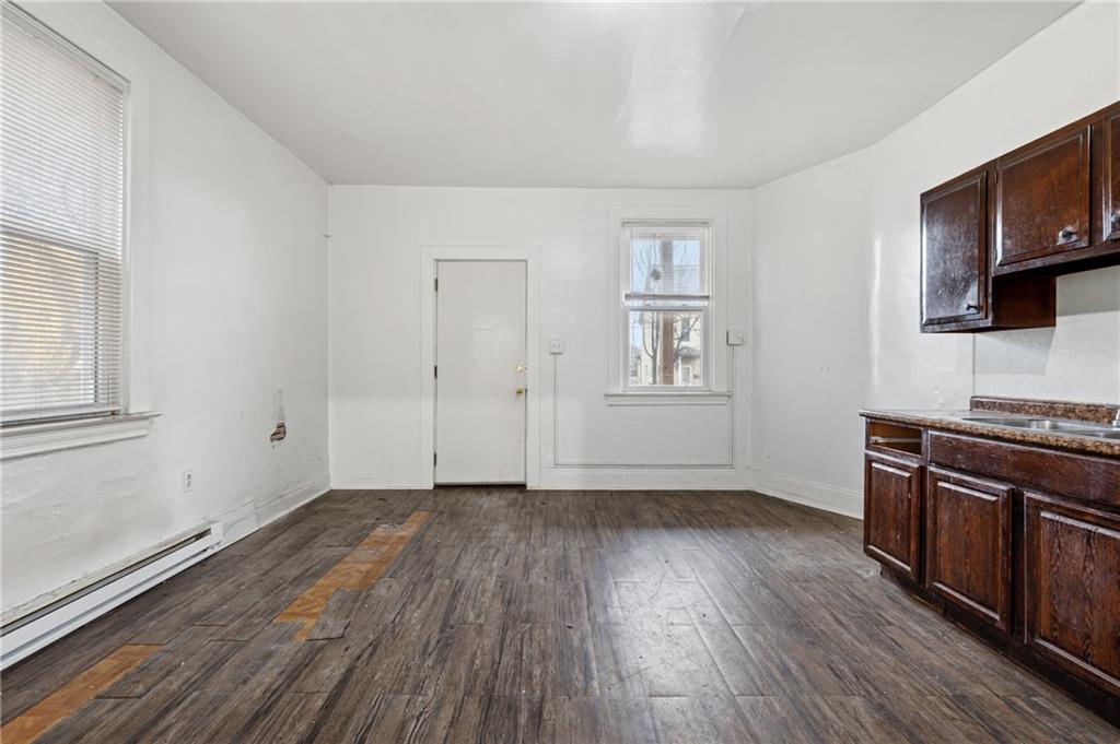 902 Robinson Street McKees Rocks, PA 15136 - Photo 8 of 31 wooden floor in an empty room with a window