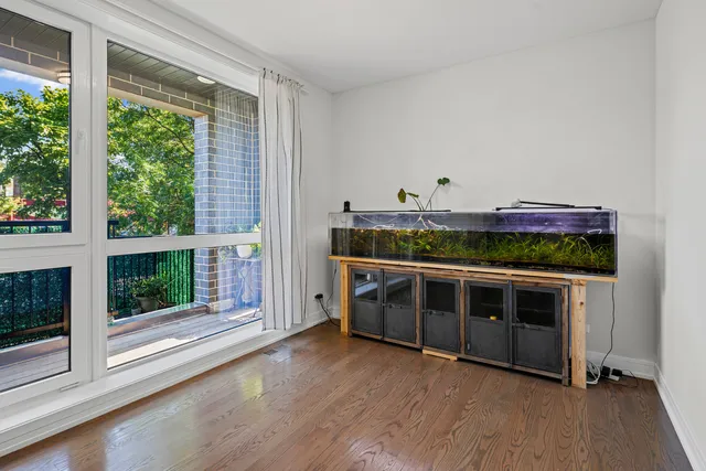 a view of a room with wooden floor and windows