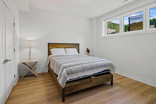 a bedroom with a bed and wooden floor