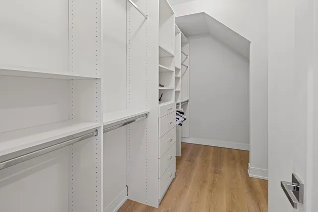 a view of walk in closet with empty racks