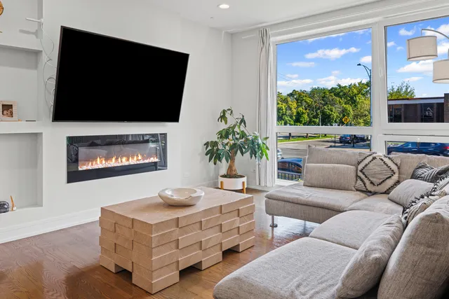 a living room with furniture fireplace and window