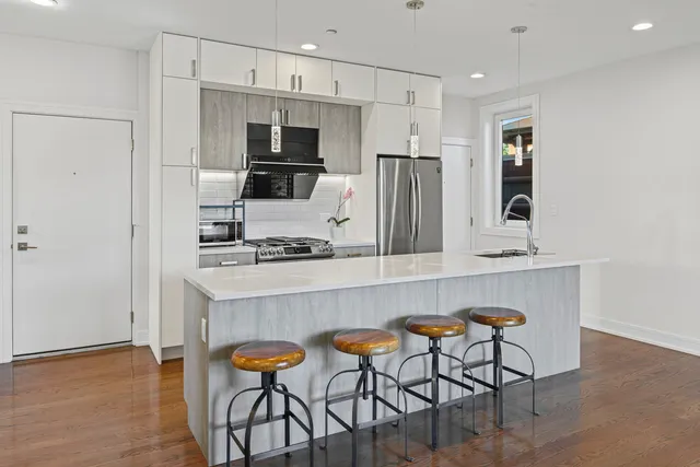 a kitchen with stainless steel appliances a microwave a stove and refrigerator