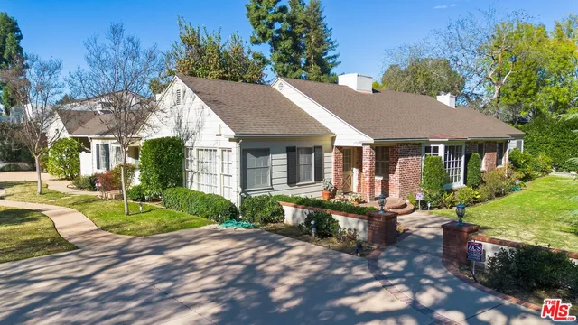 a front view of a house with garden and porch