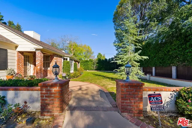 a kitchen with a refrigerator a stove a sink and white cabinets