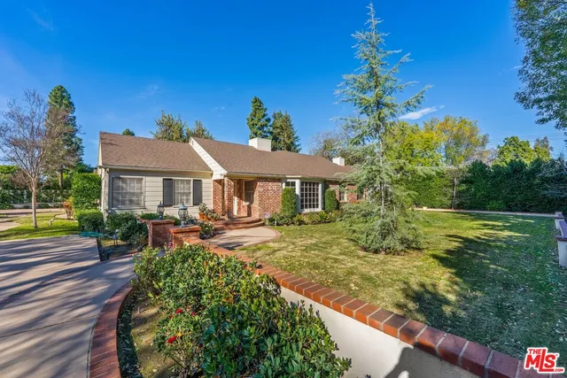 a front view of house with yard and outdoor seating