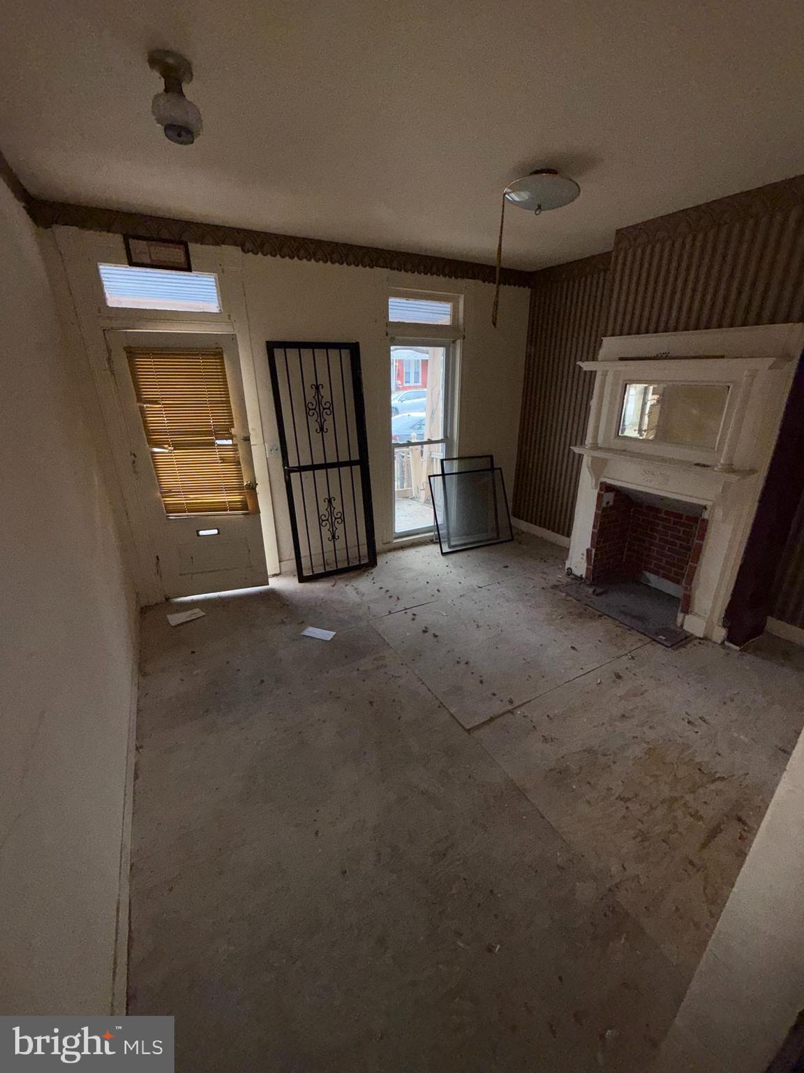 3113 Barclay Street Baltimore, MD 21218 - Photo 9 of 31 a view of an empty room with window and fireplace