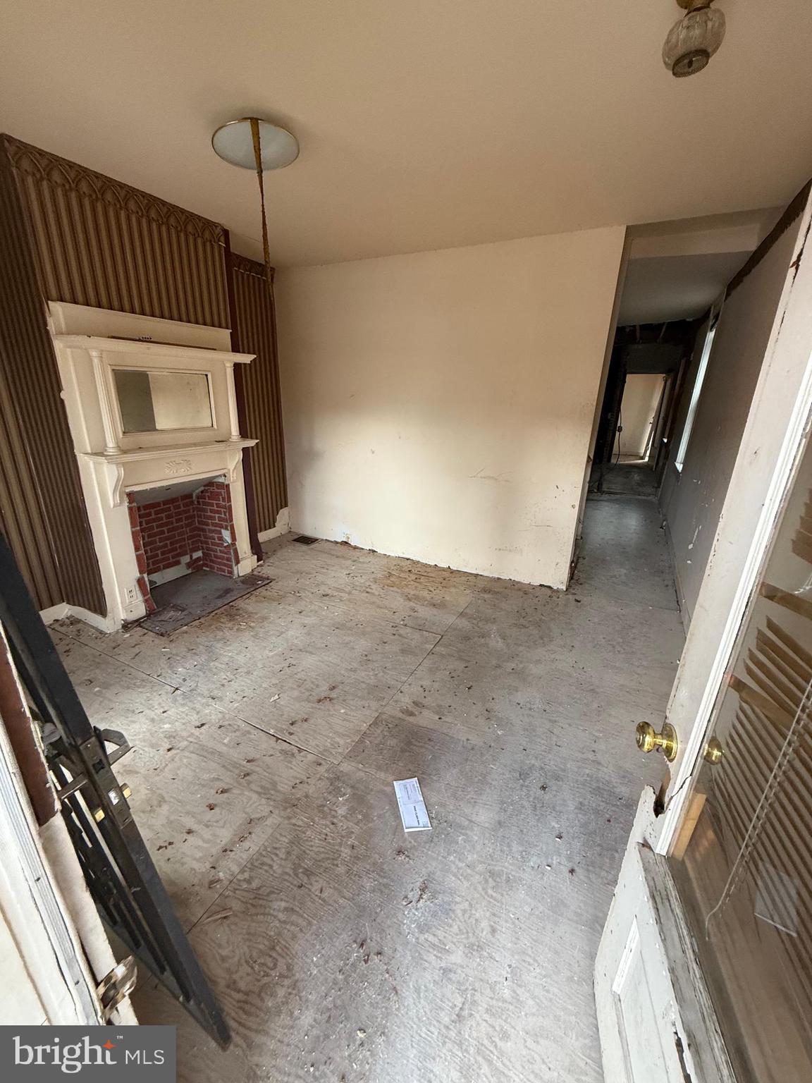3113 Barclay Street Baltimore, MD 21218 - Photo 10 of 31 a view of an empty room with a fireplace