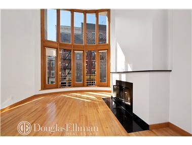 191 Spring Street, Unit PH Manhattan, NY 10012 - Photo 1 of 1 a view of an empty room with wooden floor and a window