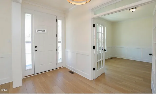 a view of a hallway with wooden floor