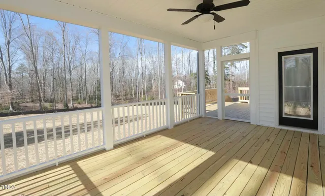 a view of a room with wooden floor and windows
